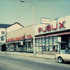 <p>Woolworth Co. was located at 678 Centre St. In this view looking towards Seaverns Ave., Publix is seen to the right and Jones Card Shop to the left of it. Beyond Hallmark, not seen, is Hailer’s Pharmacy. On the far corner of Seaverns Ave. is the Clothes Inn.</p><br/>