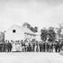 <p>Guests at a “Hoeing Surprise Party” pose at the Curtis Farm on June 4, 1873 before setting out for work in the field. A small brass band can be seen at the right. Photograph courtesy of Martha Tyer Curtis and the late Nelson Curtis Jr.<br /><br />A map annotated courtesy of Mark Bulger shows the location of the buildings shown in the photograph. This at the current intersection of Centre and Moraine Streets where a CVS Pharmacy stands today. The “X” marks the spot from which the photograph was taken:<br /><span><a href="/storage/curtis_house_1896.jpg" target="_blank">http://www.jphs.org/storage/curtis_house_1896.jpg</a></span> </p><br/><p><span>The photograph shows three buildings </span><span>in a row, with the furthest away being a house - note the porch roof. Beyond </span><span>the corner of the porch roof, a close look shows another house in the </span><span>background. That would be the B.F. Wing house on the corner of Boylston S</span><span>treet.</span></p><br/>
