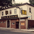<p>Green St. Station pub at 131-135 Green St. This location was also home to Kilgariff’s and The Bog pubs. ca. 1988.</p><br/><p><em>The following article speaks to the Green Street Station’s role in modern music history. Written by <span class="bold">Michael Marotta, it appeared in the April 3, 2009 edition of the Boston Herald and is used with permission. © Copyright by the Boston Herald and Herald Media.<br /></span></em></p><br/><p><span class="Heading">Boston remembers Kurt Cobain</span><br /> <span class="bold">By Michael Marotta</span></p><br/><p><span class="articleBegin">O</span>n Sept. 24, 1991, Nirvana’s “Nevermind” was unleashed. It would go on to dethrone Michael Jackson from the top of the Billboard charts, sell more than 10 million copies and change the face of music.</p><br/><p>The same day “Nevermind” hit store shelves, Nirvana was in Boston, getting ready for the second of two shows at Axis on Lansdowne Street. Two days earlier, as Kurt Cobain was eating dinner at Division 16 on Boylston Street with WFNX-FM (101.7) program director Kurt St. Thomas, he asked, “So you think anybody’s going to show up to this?”</p><br/><p>About 1,000 fans lined Lansdowne Street to get into that first Axis show, a WFNX birthday bash that also featured the then-unknown Smashing Pumpkins and local band Bullet LaVolta.</p><br/><p>As the 15th anniversary of Cobain’s suicide arrives this Sunday, Nirvana’s prefame local club shows have become the stuff of legend. Three venues loom large in Nirvana’s local legacy: Green Street Station in Jamaica Plain, ManRay in Cambridge and Axis on Lansdowne Street. Sadly, none remain in business today.</p><br/><p>The band’s first Hub gig was at Green Street Station on July 15, 1989, a show notable in its own right: Cobain, who broke his guitar the night before, performed the entire nine-song set without one.</p><br/><p>On April 18, 1990, Nirvana played ManRay, performing to some 75 folks piqued by the band’s “Bleach” debut. Local punk band the Bags opened. Despite its place in local lore, recollections of the event are hazy.</p><br/><p>“I was at that show, but I don’t have too many memories besides the fact that it was loud,” said the club’s longtime DJ, Chris Ewen, who did recall Cobain briefly singing an impromptu rendition of Madonna’s “Like a Prayer.”</p><br/><p>Ashmont Media’s Joyce Linehan, who booked the show, is also fuzzy on details.</p><br/><p>“I really don’t remember it being that remarkable,” Linehan said. “There weren’t a lot of people there.”</p><br/><p>But St. Thomas was.</p><br/><p>“The show blew me away,” he said. “I remember they thought it was really weird that I worked at a commercial radio station.”</p><br/><p>St. Thomas would go on to play Nirvana on the radio, but mostly in the wee hours. Eight months before “Nevermind” came out in 1991, he pleaded with Geffen Records to put Nirvana on the bill for the ’FNX eighth anniversary show.</p><br/><p>“I just wanted to book my favorite band,” St. Thomas said. “I had no idea what was going to happen. They agreed to play the gig, and it was the only free gig they ever played for a radio station.”</p><br/><p>A month before the 1991 Axis show, St. Thomas was the first DJ to play “Smells Like Teen Spirit” on the radio.</p><br/><p>“There was nothing on ’FNX like it,” he recalled. “No other song immediately ignited a response like that. But nobody knew the name. People would call in and say, ‘What was that mosquito song?’ ”</p><br/><p>By the time the Axis show rolled around that September, fans were ready to embrace a new sound called grunge.</p><br/><p>Nirvana then agreed to play a second gig after being, as St. Thomas puts it, “bummed” by the 21-plus age policy at the show. So they scheduled a second Axis performance the next night with an 18-and-older admission policy in effect.</p><br/><p>By the time Nirvana hit the stage, “Nevermind” was in stores. Cobain would never again have to worry about people showing up to a show.</p><br/><p> </p><br/>