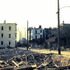 <p>Mansur Street during demolition of parts of the neighborhood to build the Hennigan School at what became 200 Heath Street. Note the newly built VA Hospital in the background. Mansur ran off of Schiller Street and Schiller ran from Heath to Minden Streets. Photograph courtesy of Robert Albee.</p><br/>