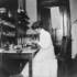 <p><span style="color: #0d0d0d;">Bessie Simpson in lab with microscope.</span></p><br/><p>The photographs in this gallery are drawn from the “Bessie H. Simpson Collection” and are provided courtesy of Janet McIver, 2557 Evergreen Drive, Penticton BC V2A 7Y2, Canada <clanchowder[at]shaw.ca>  Higher resolution versions of these images may be downloaded from http://www.jphs.org/dimock-high-resolution-images/<br /><br /></p><br/>