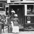  Car 5195, an Arborway subway car, loads passengers on Centre Street ca. 1912. This Type 4 car had a new design with an enclosed cab and a fare collection station right inside the front door. Before the collection stations were installed in cars, conductors would roam from seat to seat collecting fares. This type car had another new feature; it was designed with the controls and power to pull non-powered cars as a trailer. Previously, all cars were self-contained with their own traction motors and ability to draw power from the overhead catenary. In the background a twelve bench open summer car can be seen. 